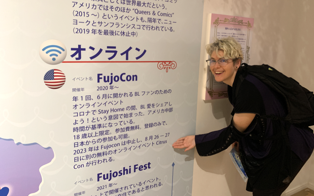 The author standing in front of the map, pointing excitedly at FujoCon.