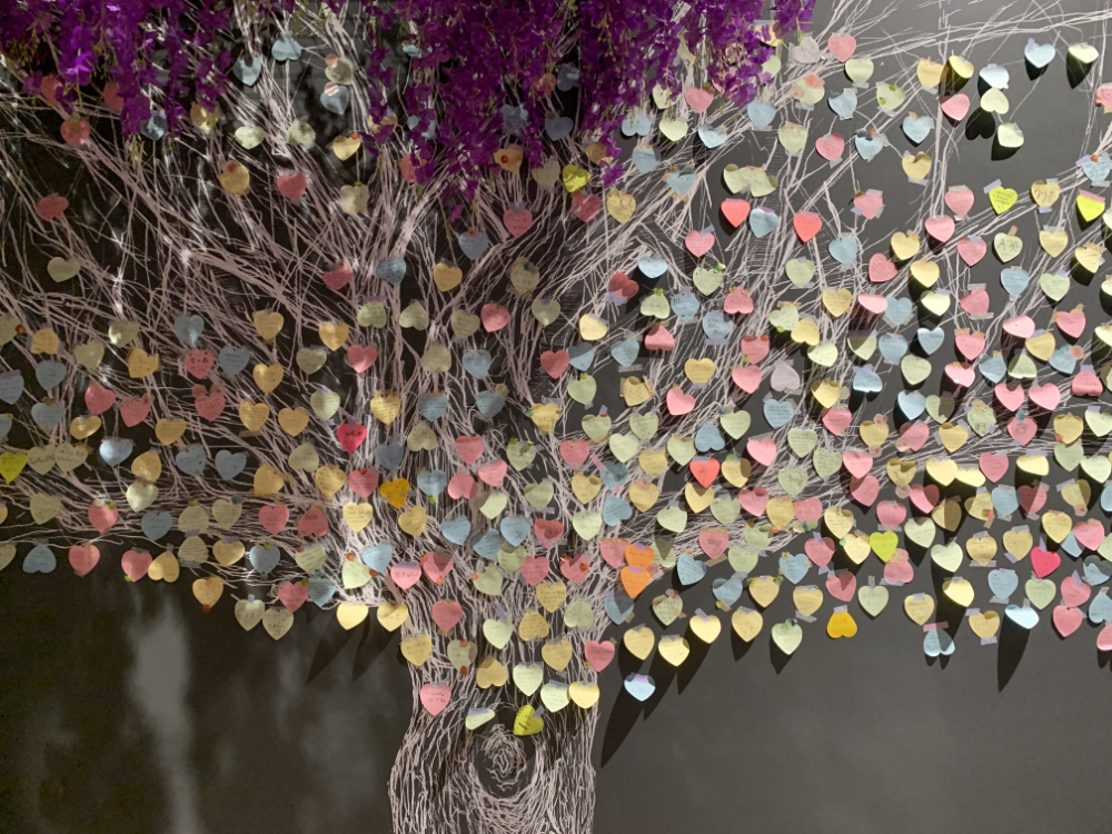 A gigantic wisteria tree made of comments from guests on heart post-its.